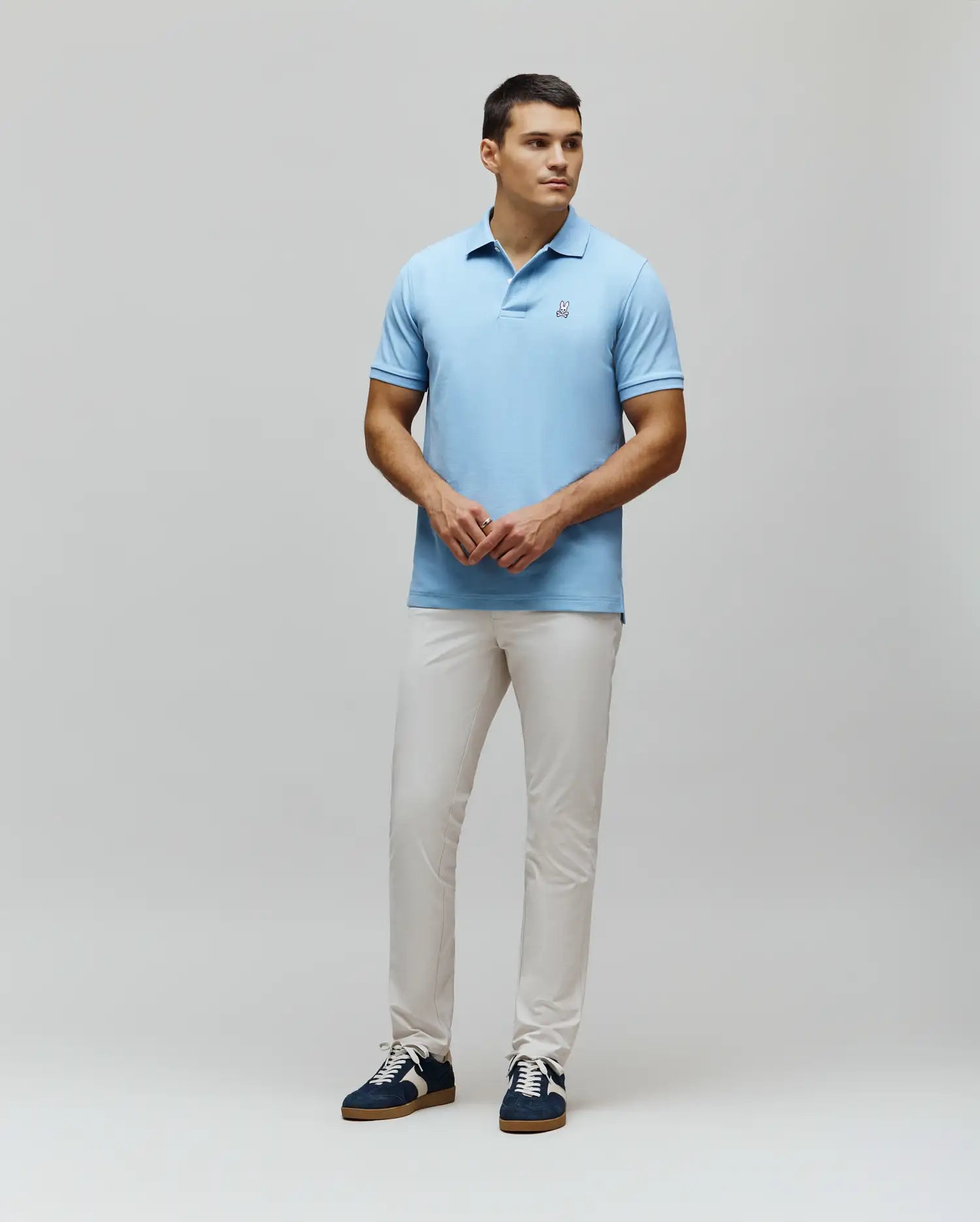 MENS CLASSIC PIQUE POLO in light blue, featuring a classic fit and pique knit texture. Small embroidered white Psycho Bunny skull logo on the left chest.