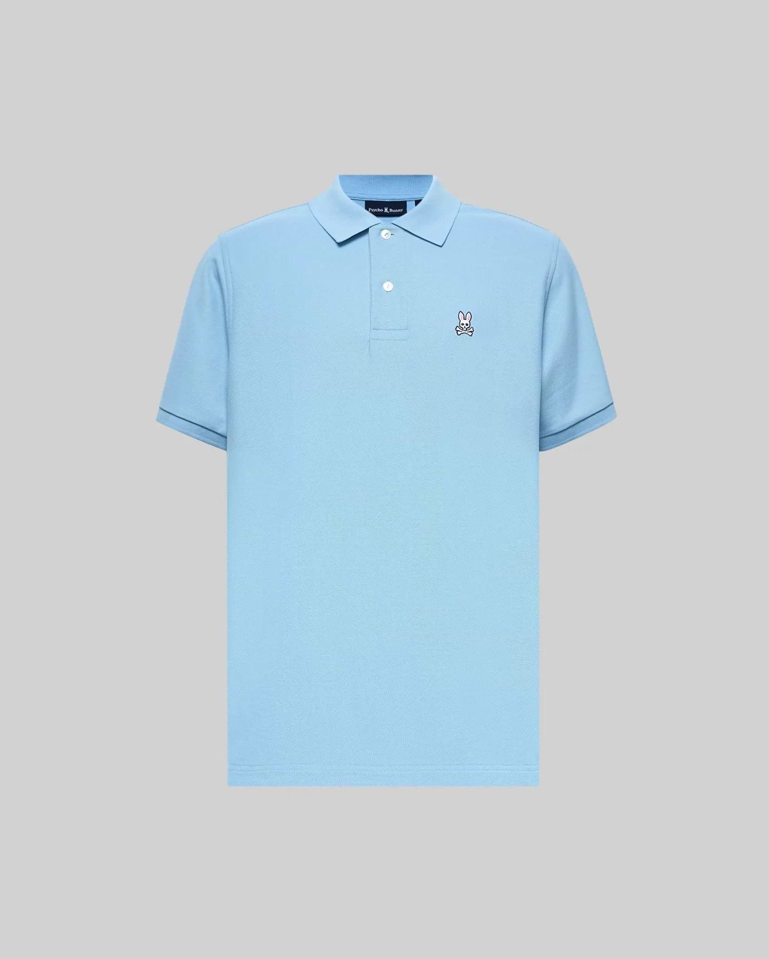 Mens Classic Pique Polo in light blue, classic fit, pique knit fabric. Features a small embroidered Psycho Bunny skull logo on the left chest, two white buttons, and dark blue tipping on ribbed cuffs.