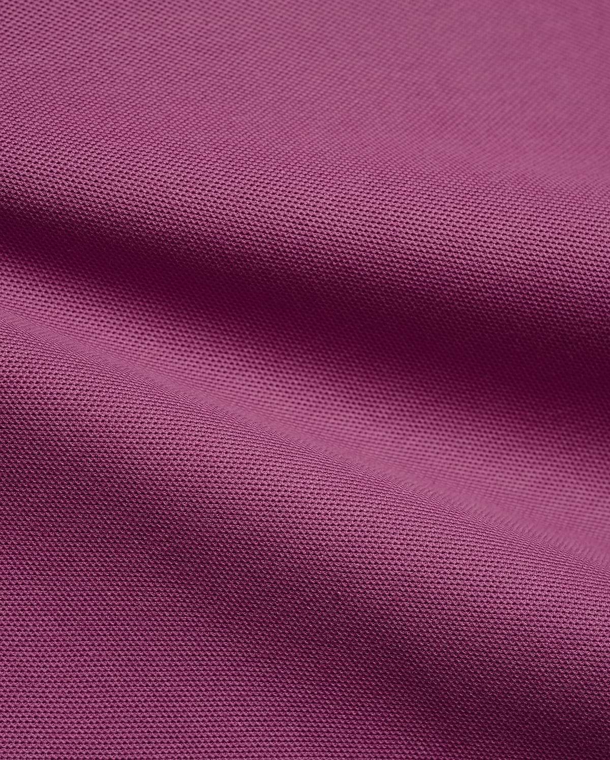 Psycho Bunny Mens Classic Pique Polo fabric in a vibrant deep magenta, highlighting the premium, breathable pique knit texture with elegant, soft folds, perfect for refined streetwear.