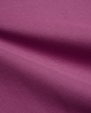 Psycho Bunny Mens Classic Pique Polo fabric in a vibrant deep magenta, highlighting the premium, breathable pique knit texture with elegant, soft folds, perfect for refined streetwear.
