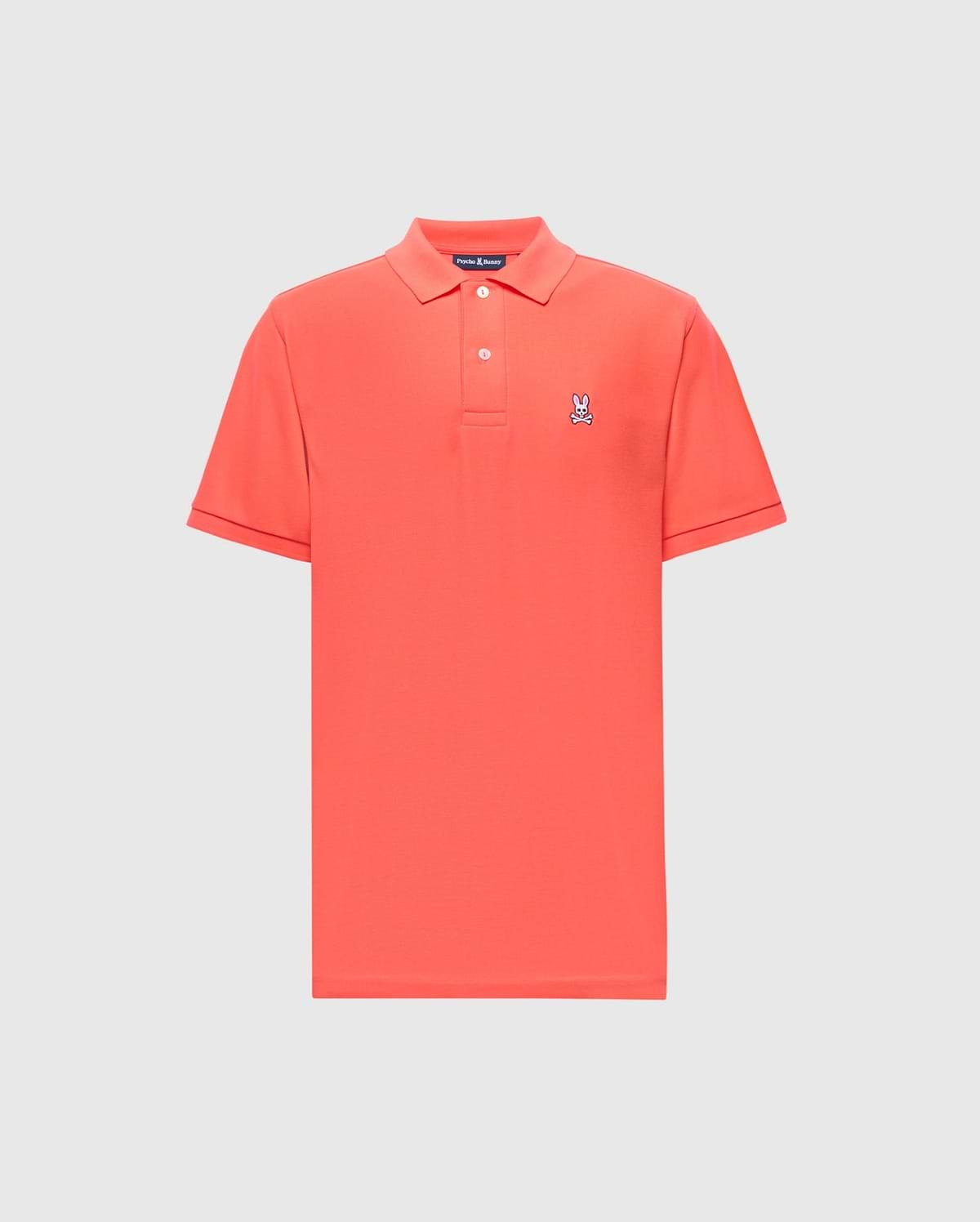 The Psycho Bunny MENS CLASSIC PIQUE POLO - B6K001F200 is a red shirt featuring a traditional collar and short sleeves, made from premium Pima cotton with an embroidered Bunny logo on the left chest, set against a plain white background.