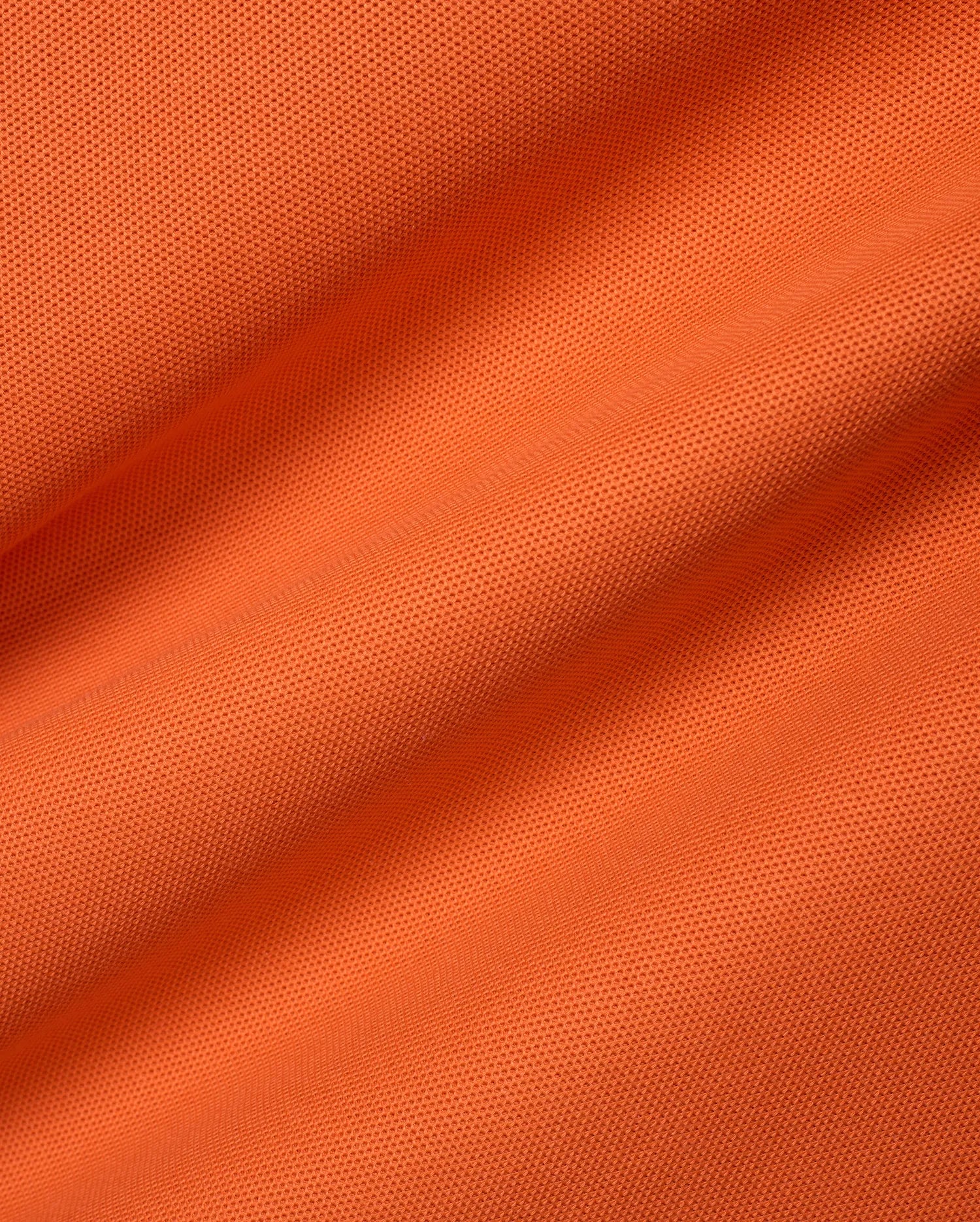 Men's Classic Pima Pique Polo in a bold, vibrant orange hue, meticulously crafted from premium, breathable textured pique fabric, embodying refined streetwear with a classic fit. (6)