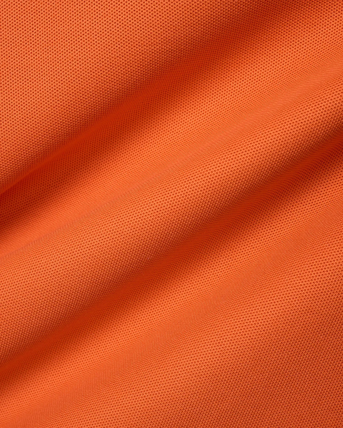 Men's Classic Pima Pique Polo in a bold, vibrant orange hue, meticulously crafted from premium, breathable textured pique fabric, embodying refined streetwear with a classic fit. (6)