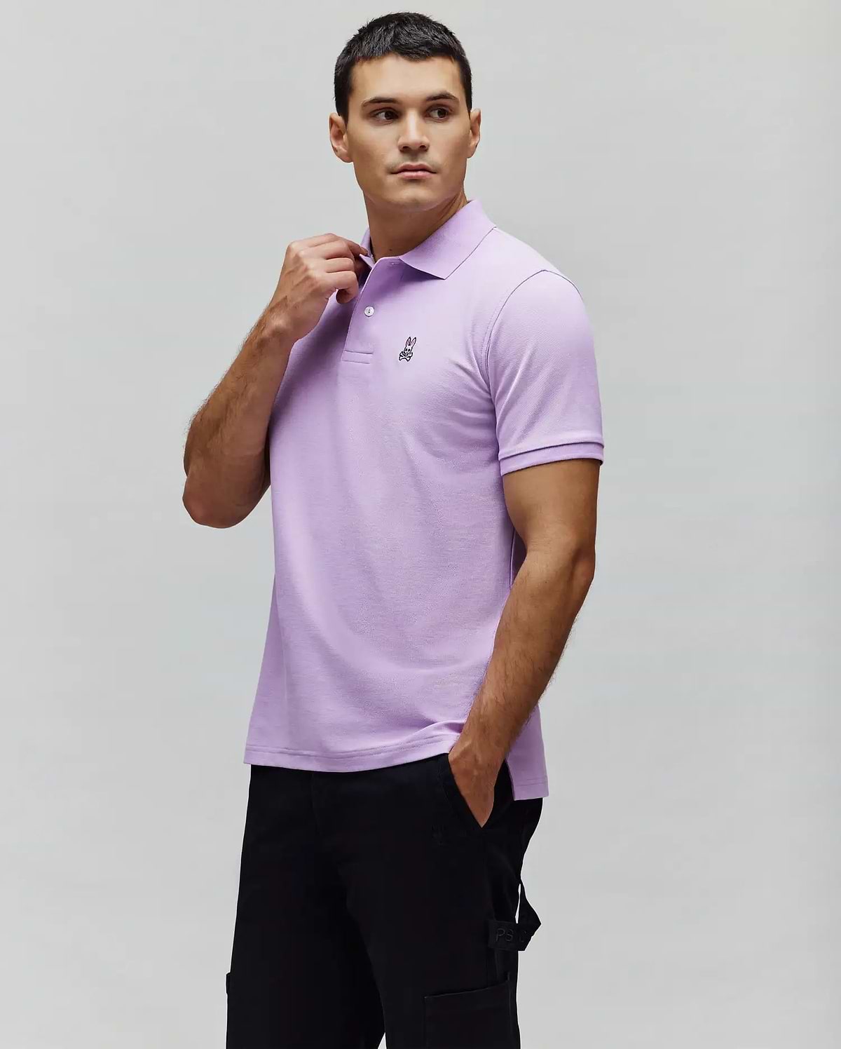 Mens Classic Pique Polo in lavender, featuring a classic fit, pique texture, and a small black embroidered Psycho Bunny skull logo on the left chest with a two-button placket. (1)