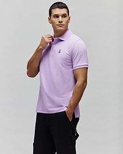 Mens Classic Pique Polo in lavender, featuring a classic fit, pique texture, and a small black embroidered Psycho Bunny skull logo on the left chest with a two-button placket. (1)