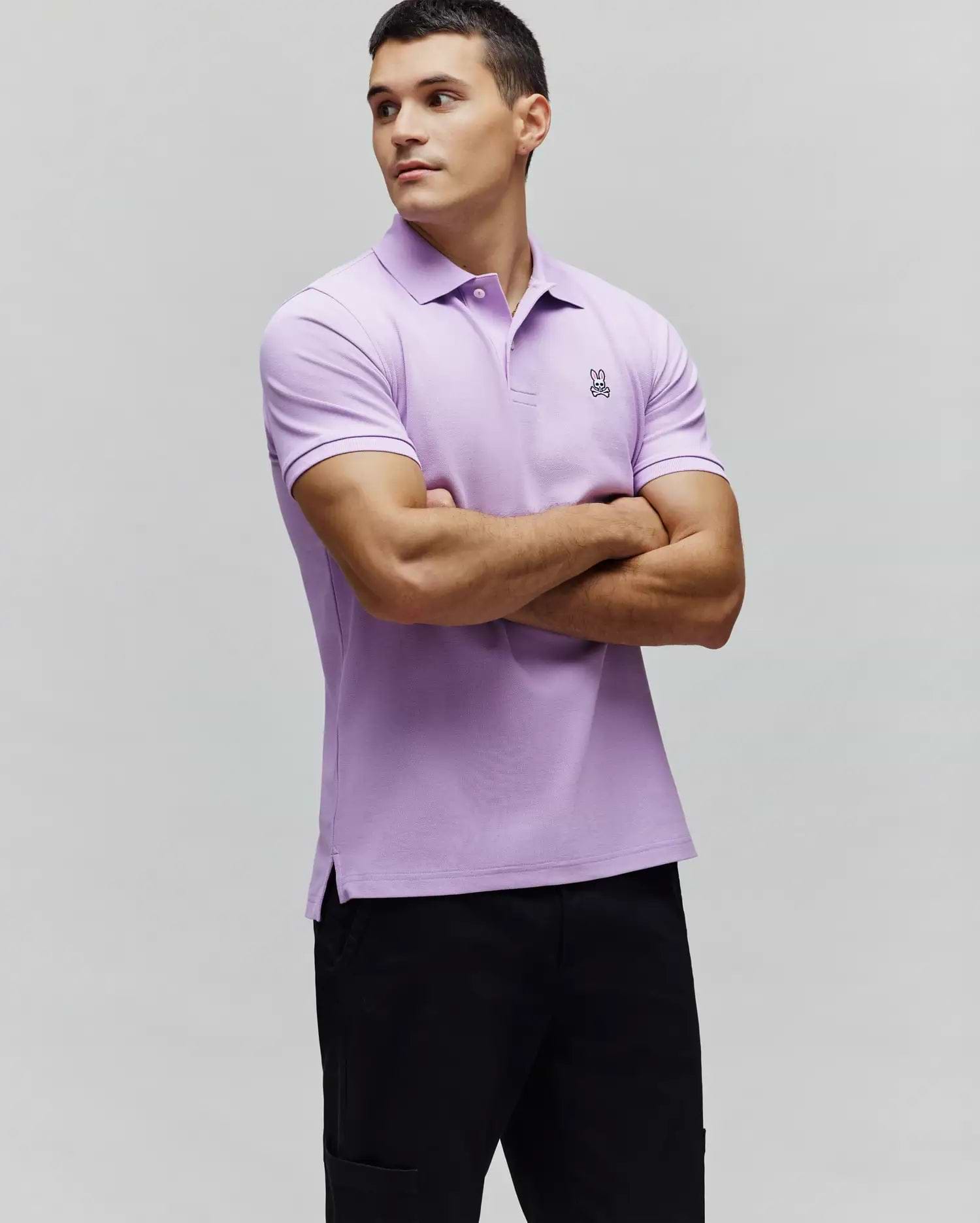MENS CLASSIC PIQUE POLO in lavender, slim fit, featuring a white two-button placket, ribbed cuffs, side vents, and a small black and white embroidered Psycho Bunny skull logo on the left chest. (5)