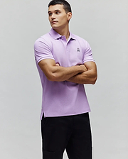 MENS CLASSIC PIQUE POLO in lavender, slim fit, featuring a white two-button placket, ribbed cuffs, side vents, and a small black and white embroidered Psycho Bunny skull logo on the left chest. (5)