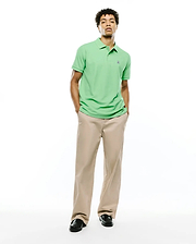 Mens Classic Pique Polo in bright lime green, with a classic fit, textured pique knit, two-button placket, and a small embroidered Psycho Bunny skull logo on the left chest.