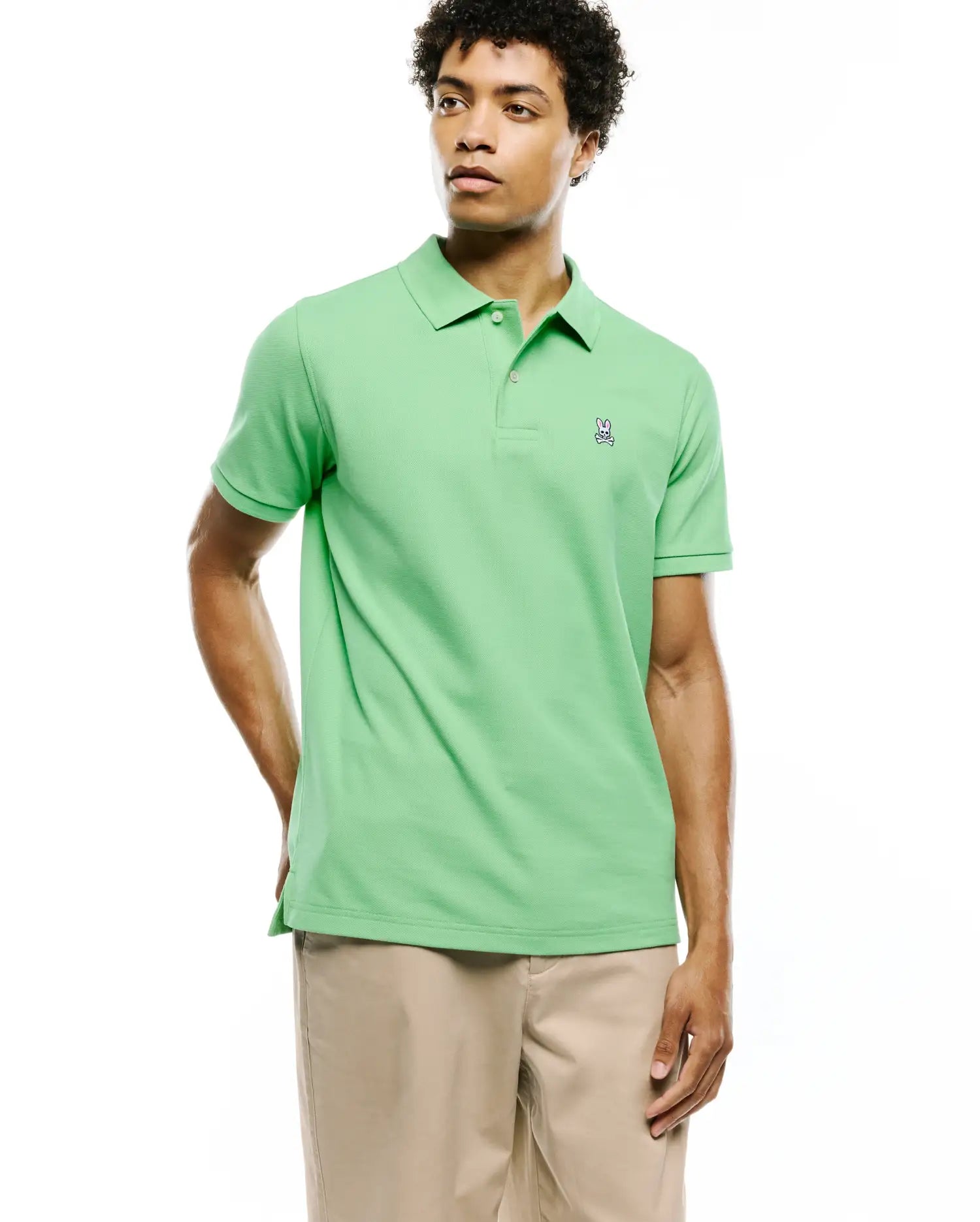 Mens Classic Pique Polo in vibrant lime green, featuring a classic fit, textured pique fabric, and a small embroidered Psycho Bunny skull logo on the left chest.
