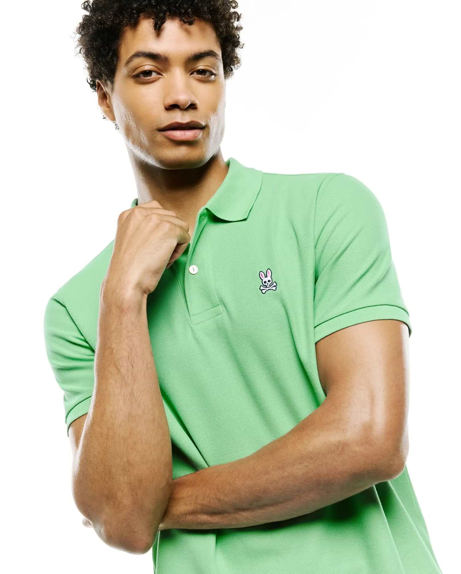 Mens Classic Pique Polo in vibrant lime green, featuring a classic fit, two-button placket with white buttons, and a detailed embroidered Psycho Bunny skull logo on the left chest.