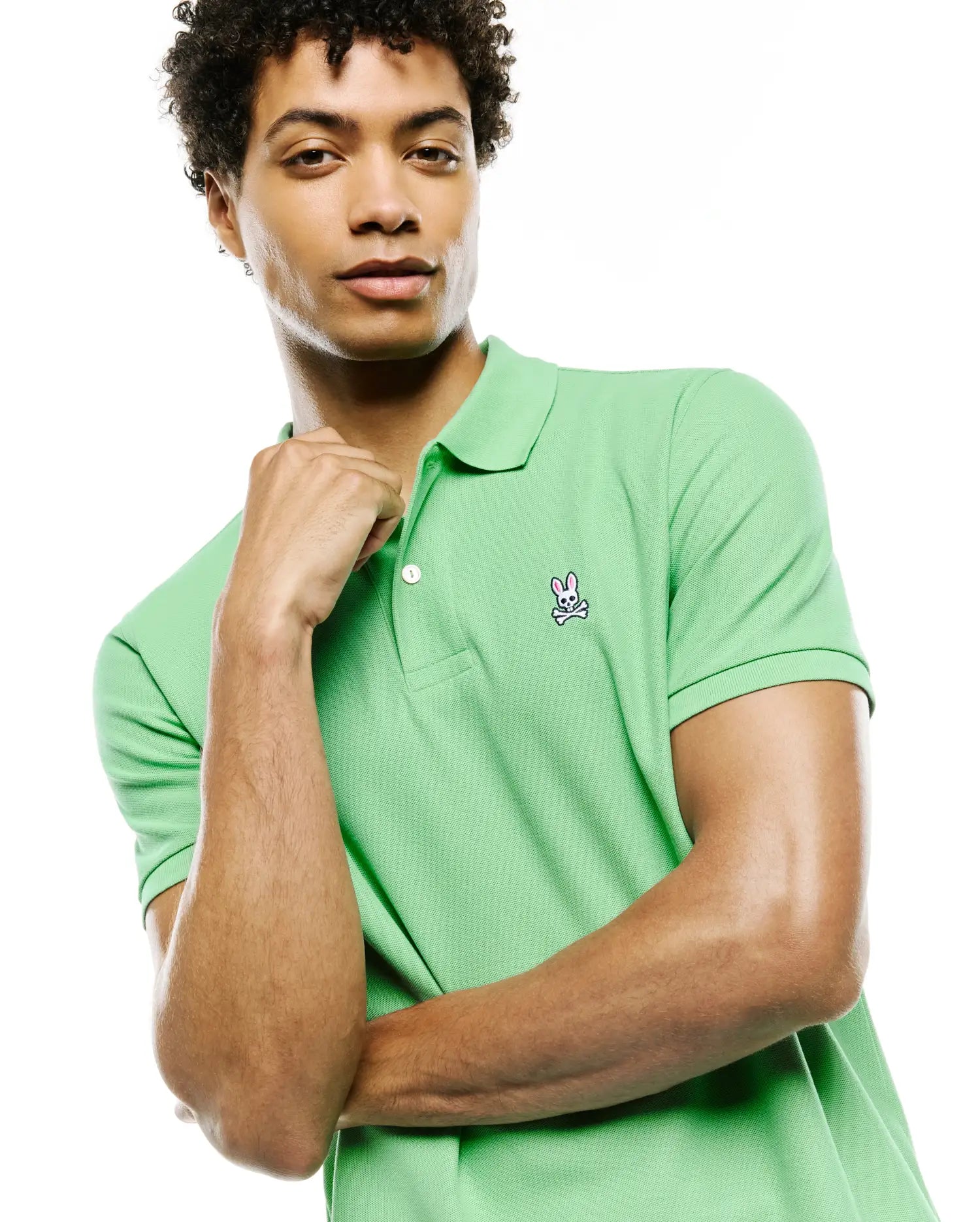 Mens Classic Pique Polo in vibrant lime green, featuring a classic fit, two-button placket with white buttons, and a detailed embroidered Psycho Bunny skull logo on the left chest.