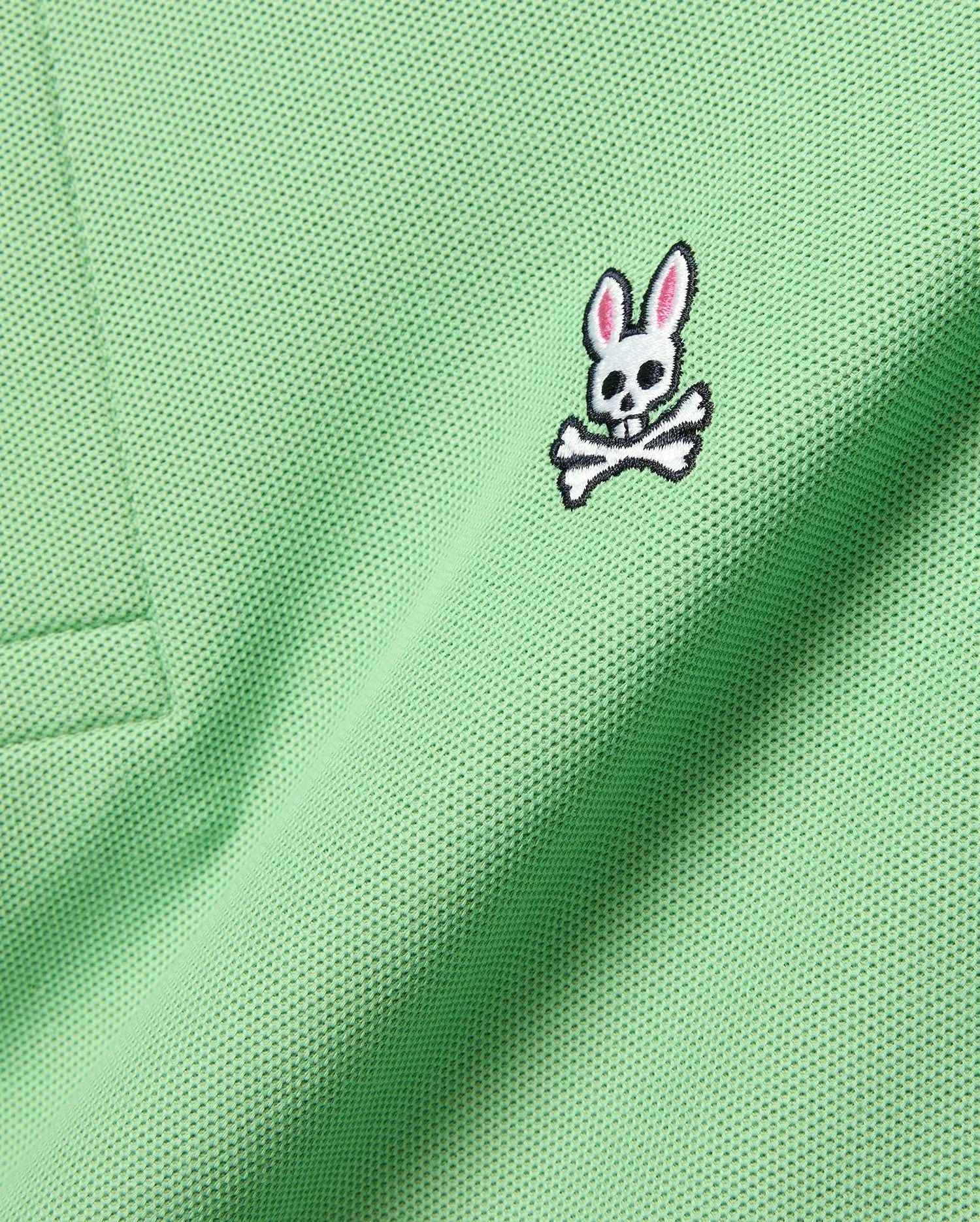 Mens Classic Pique Polo in vibrant light green, showcasing a detailed embroidered white, black, and pink Psycho Bunny skull logo on the left chest.