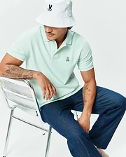 Mens Classic Pique Polo in light mint green, featuring a classic fit and textured pique fabric with a small embroidered Psycho Bunny skull logo on the left chest. (4)