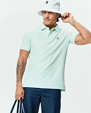 Mens Classic Pique Polo in mint green, crafted from textured pique fabric with a classic fit, two-button placket, and a small embroidered Psycho Bunny skull logo on the left chest. (1)