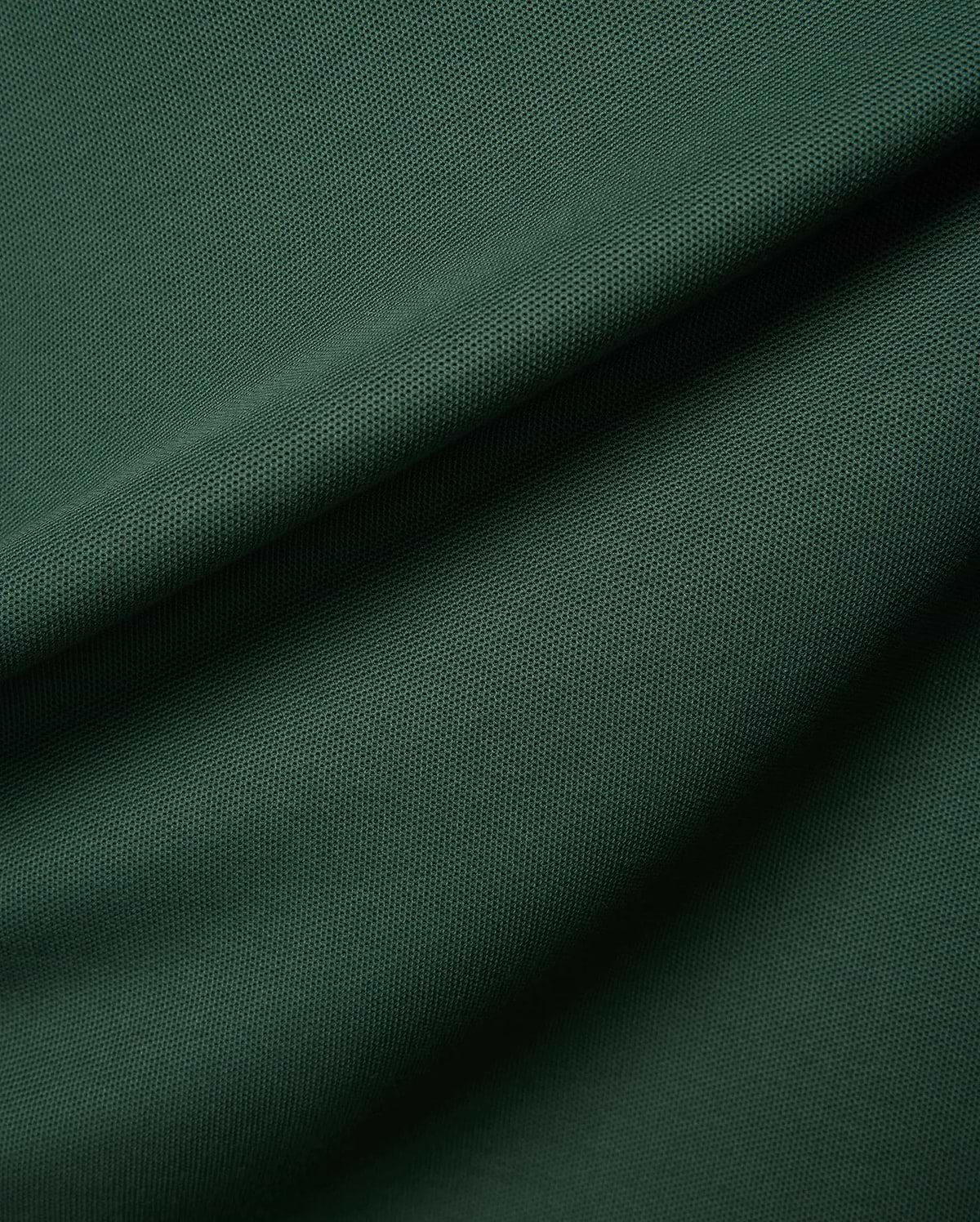 Deep forest green Mens Classic Pique Polo fabric, highlighting the signature textured pique weave with elegant folds and shadows, reflecting Psycho Bunny's premium quality and refined streetwear style.