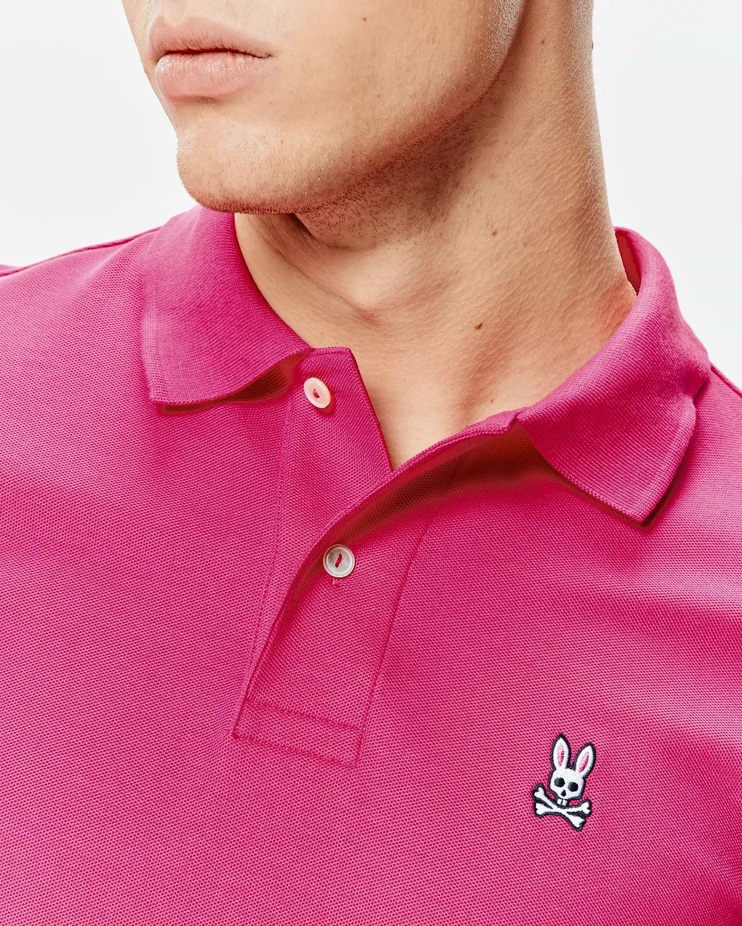 Mens Classic Pique Polo in vibrant pink pique knit, classic fit, with a two-button placket and small embroidered white and black Psycho Bunny skull logo on the left chest. (3)