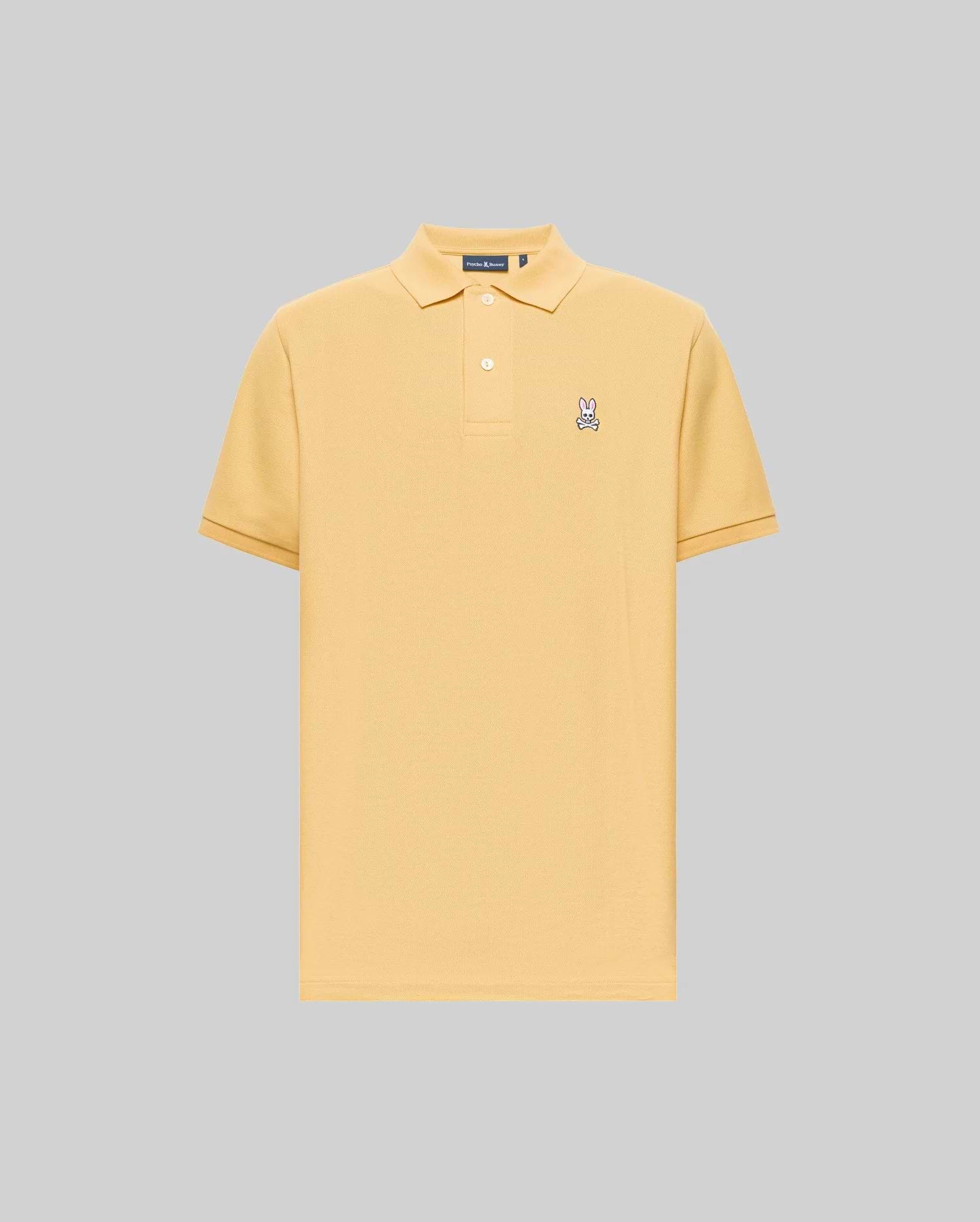 The Psycho Bunny MENS CLASSIC PIQUE POLO - B6K001F200 is a light yellow, short-sleeve Pima cotton polo with a collar, two buttons, and an embroidered Bunny logo on the left chest, set against a plain gray background. (1)