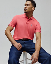 Mens Classic Pique Polo in vibrant coral with a textured pique knit and a classic fit, featuring a small, embroidered pink and white Psycho Bunny skull logo on the left chest. (6)