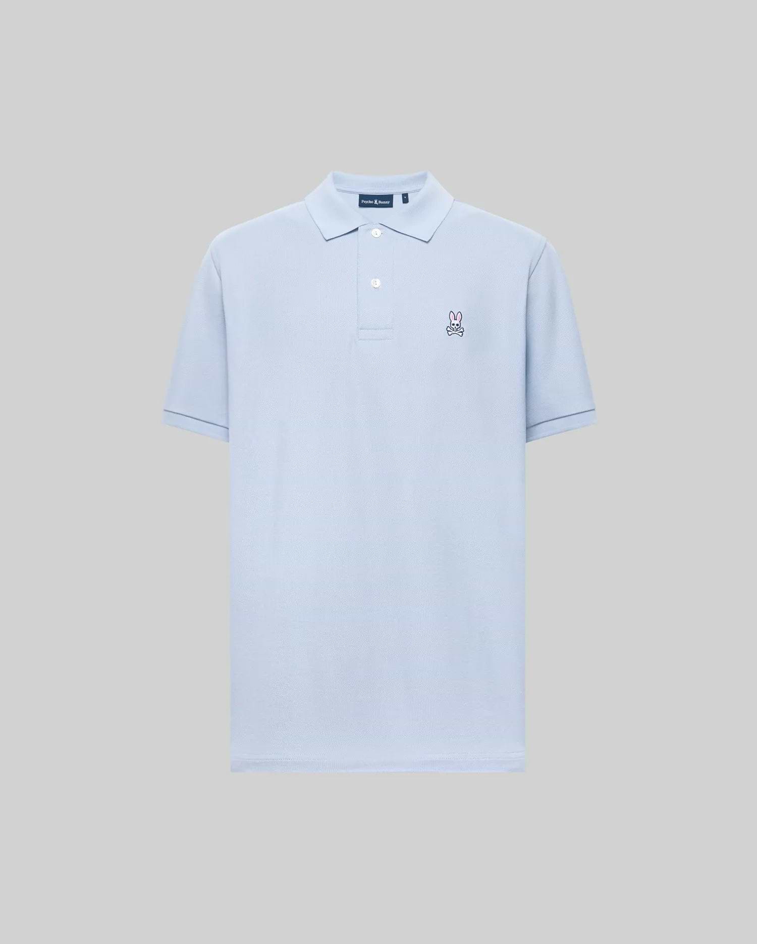 The Psycho Bunny MENS CLASSIC PIQUE POLO (B6K001F200) is a light blue short-sleeved Pima cotton men’s polo with a collar, two buttons, and an embroidered bunny logo on the left chest, shown on a plain gray background.