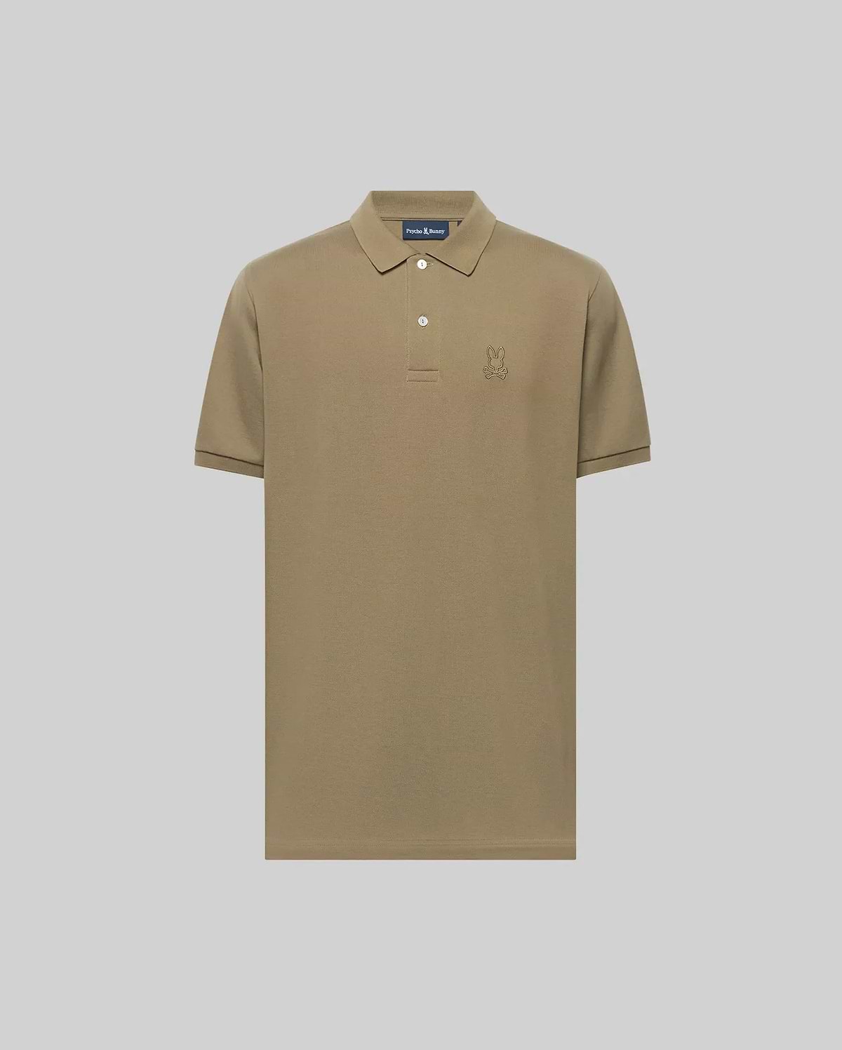 The Psycho Bunny MENS JAMES PIQUE POLO (B6K945D200) is a khaki short-sleeve Pima cotton polo with a collar, two white buttons, and an embroidered bunny logo on the left chest, shown against a plain light gray background. (1)