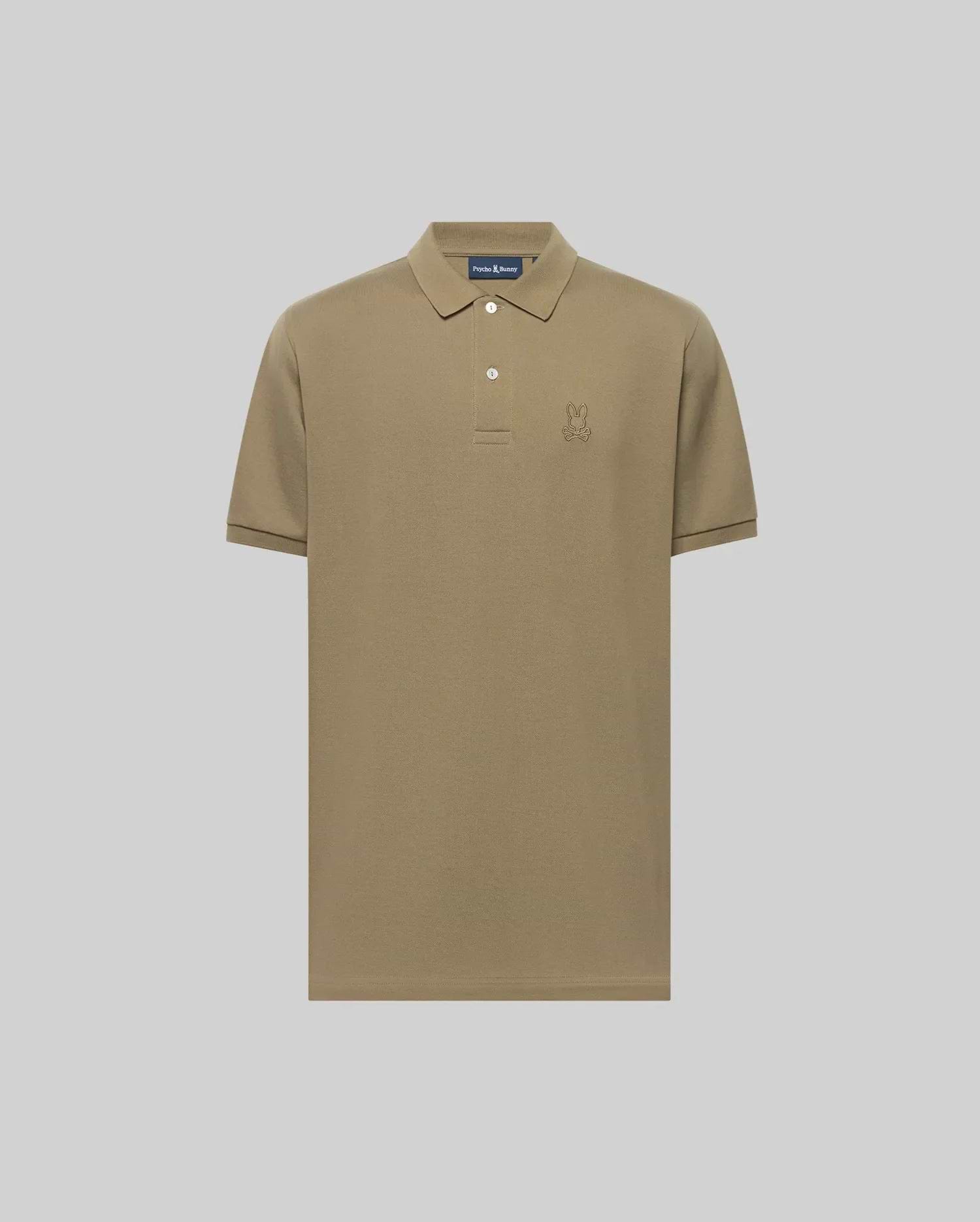 The Psycho Bunny MENS JAMES PIQUE POLO (B6K945D200) is a khaki short-sleeve Pima cotton polo with a collar, two white buttons, and an embroidered bunny logo on the left chest, shown against a plain light gray background. (1)
