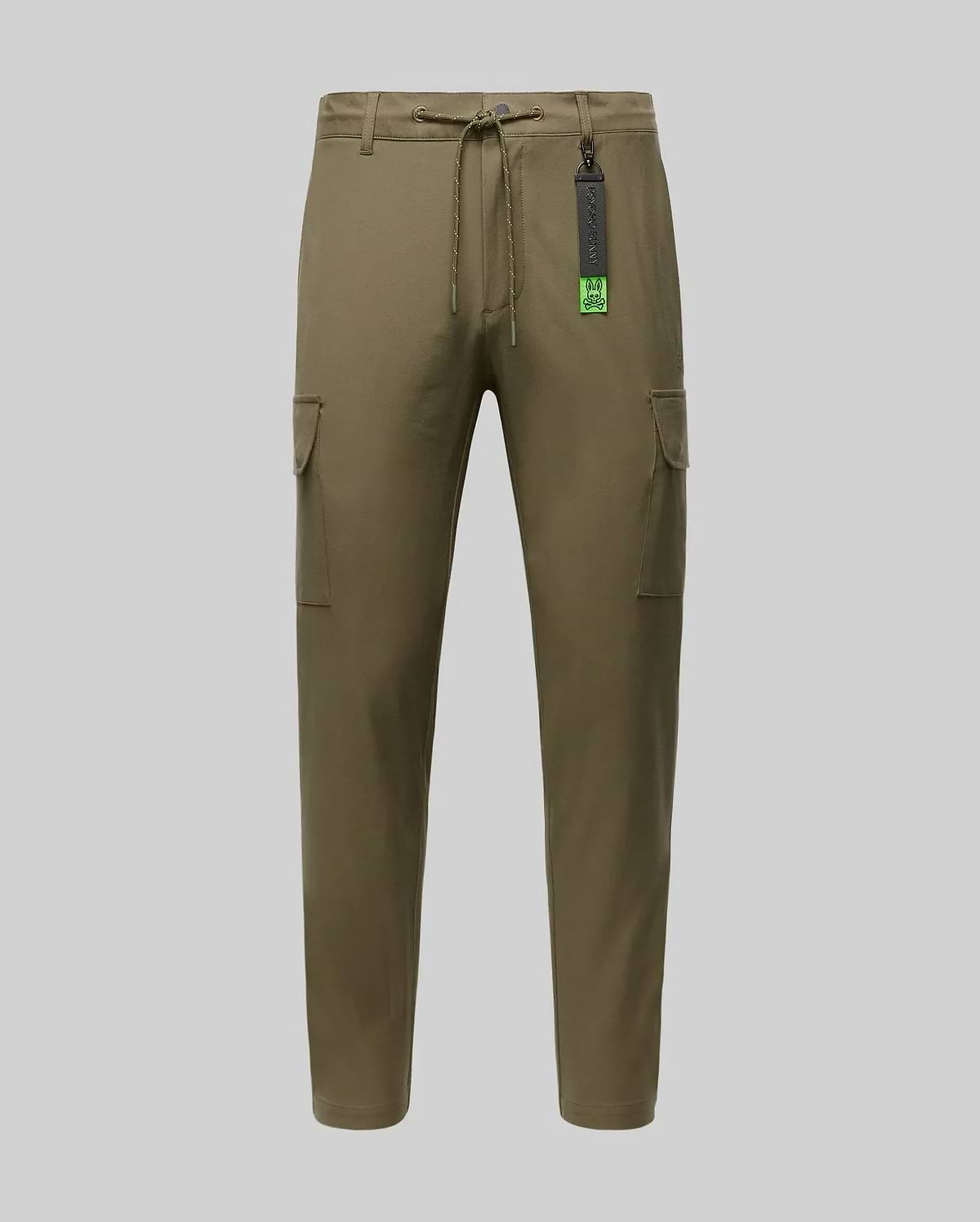 The Psycho Bunny MENS LLOYD CARGO JOGGER (B6P159B200) features khaki green fabric, a drawstring waist, side pockets, and a black tag near the waistband, shown on a plain light grey background.