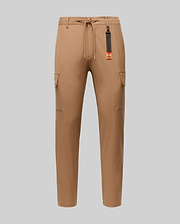 The Psycho Bunny MENS LLOYD CARGO JOGGER - B6P159B200 features tan fabric, elastic waistband, drawstring, side pockets, and a black-and-orange tag on a belt loop—perfect for upgrading your men's pants collection. Shown on a plain light gray background.