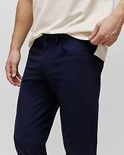 Mens Maverick 10k Step Pant in navy blue, featuring a slim fit and smooth performance fabric. A small, embroidered Psycho Bunny skull logo is visible on the right front pocket. (2)