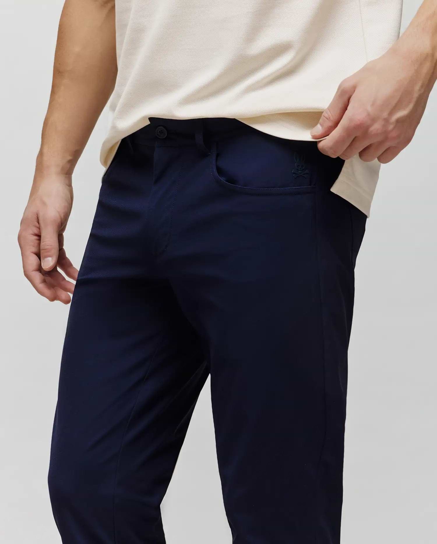 Mens Maverick 10k Step Pant in navy blue, featuring a slim fit and smooth performance fabric. A small, embroidered Psycho Bunny skull logo is visible on the right front pocket. (2)
