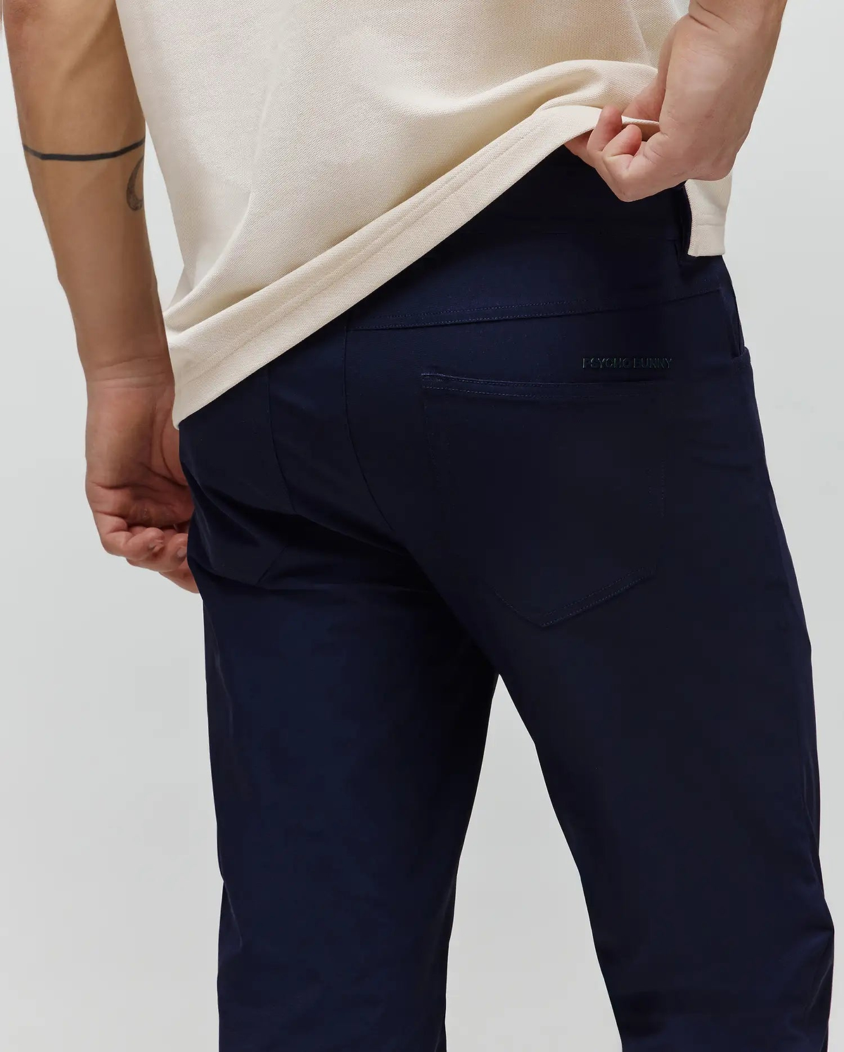 Mens Maverick 10k Step Pant in deep navy, featuring a refined slim fit and smooth performance fabric. A subtle, tonal Psycho Bunny text logo is embroidered on the right back pocket. (3)