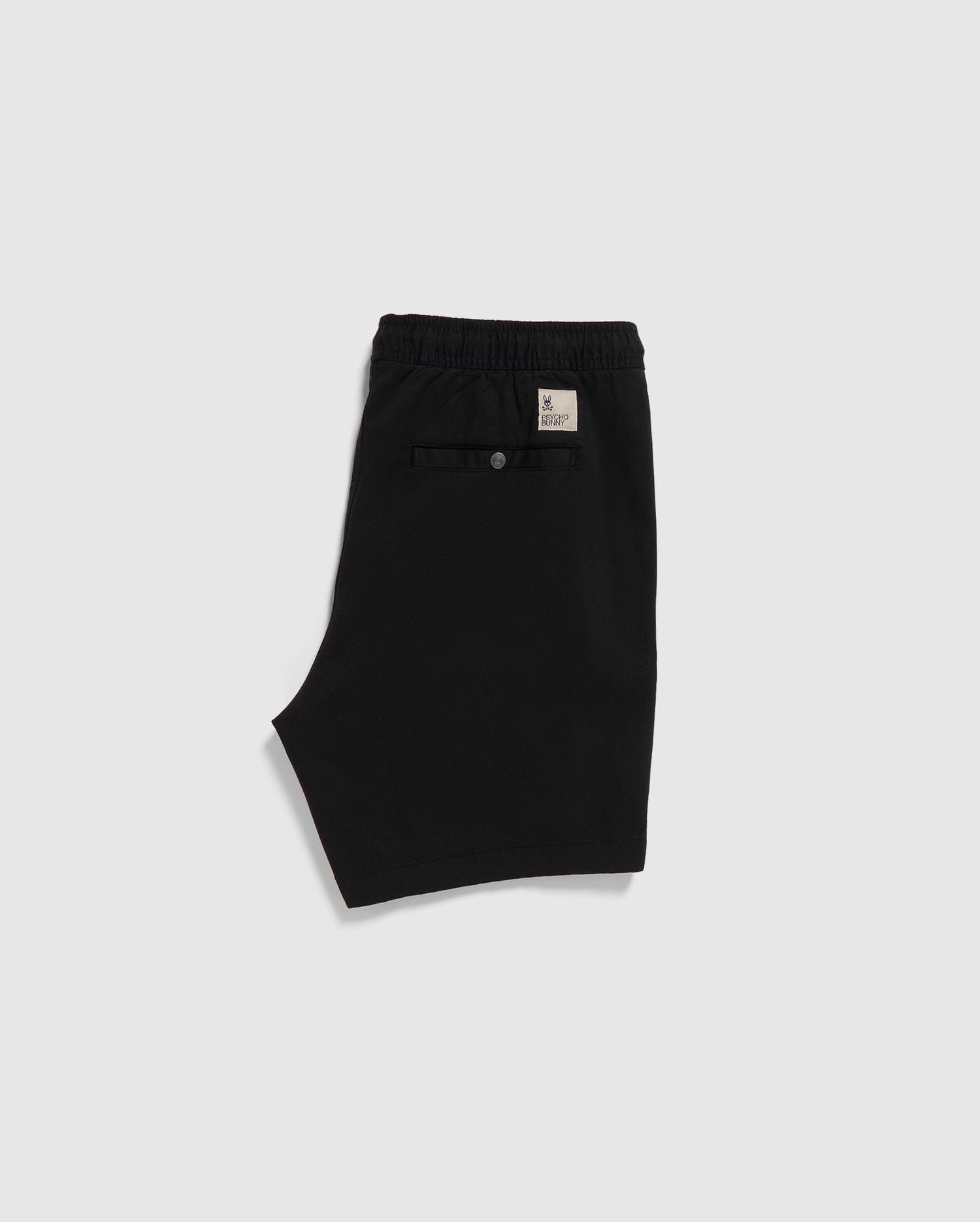 Black Psycho Bunny eco-friendly shorts with an elastic waistband and a label on the back, displayed on a plain white background.