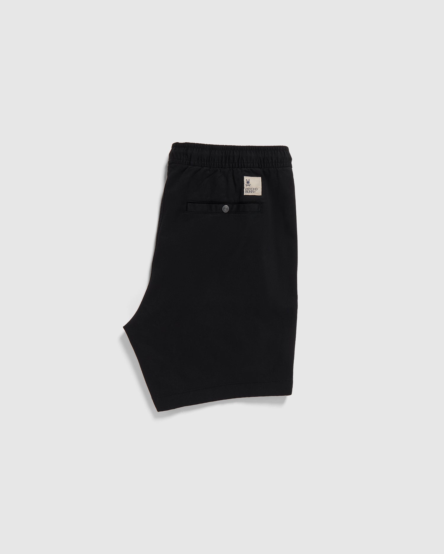 Black Psycho Bunny eco-friendly shorts with an elastic waistband and a label on the back, displayed on a plain white background.