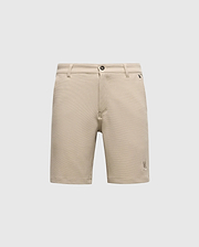 The Psycho Bunny MENS SHIRO KNIT HONEYCOMB SHORT (B6R585F200) is a beige, honeycomb-patterned piqué short with belt loops, front button and zipper closure, and a small embroidered logo near the left hem, shown on a white background.