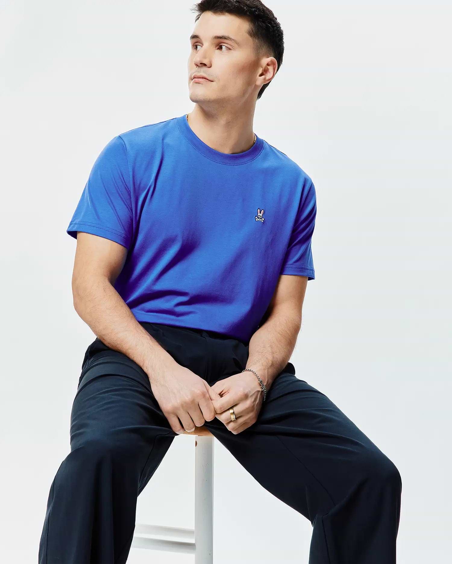 Mens Classic Crew Neck Tee in vibrant royal blue jersey knit, featuring a classic fit and a small, embroidered Psycho Bunny skull logo on the left chest with white, pink, and black details.