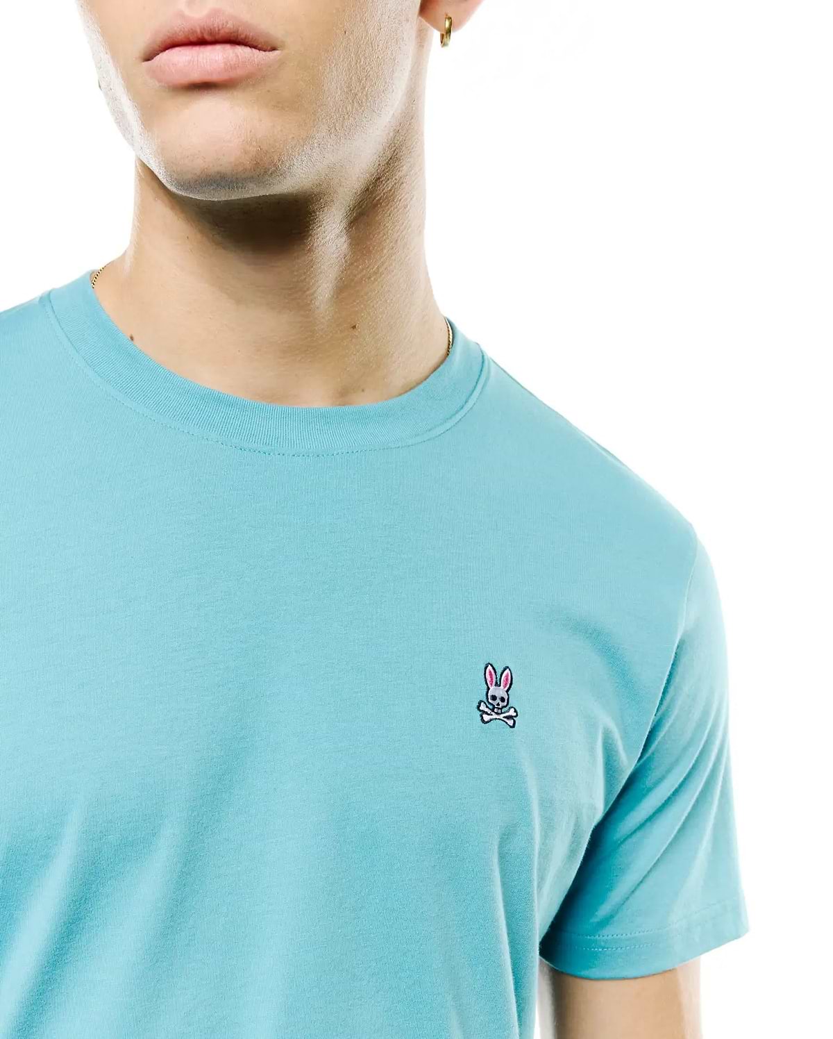 Mens Classic Crew Neck Tee in aqua blue jersey knit, featuring a small embroidered Psycho Bunny skull and crossbones logo with pink ears on the left chest, classic fit. (2)