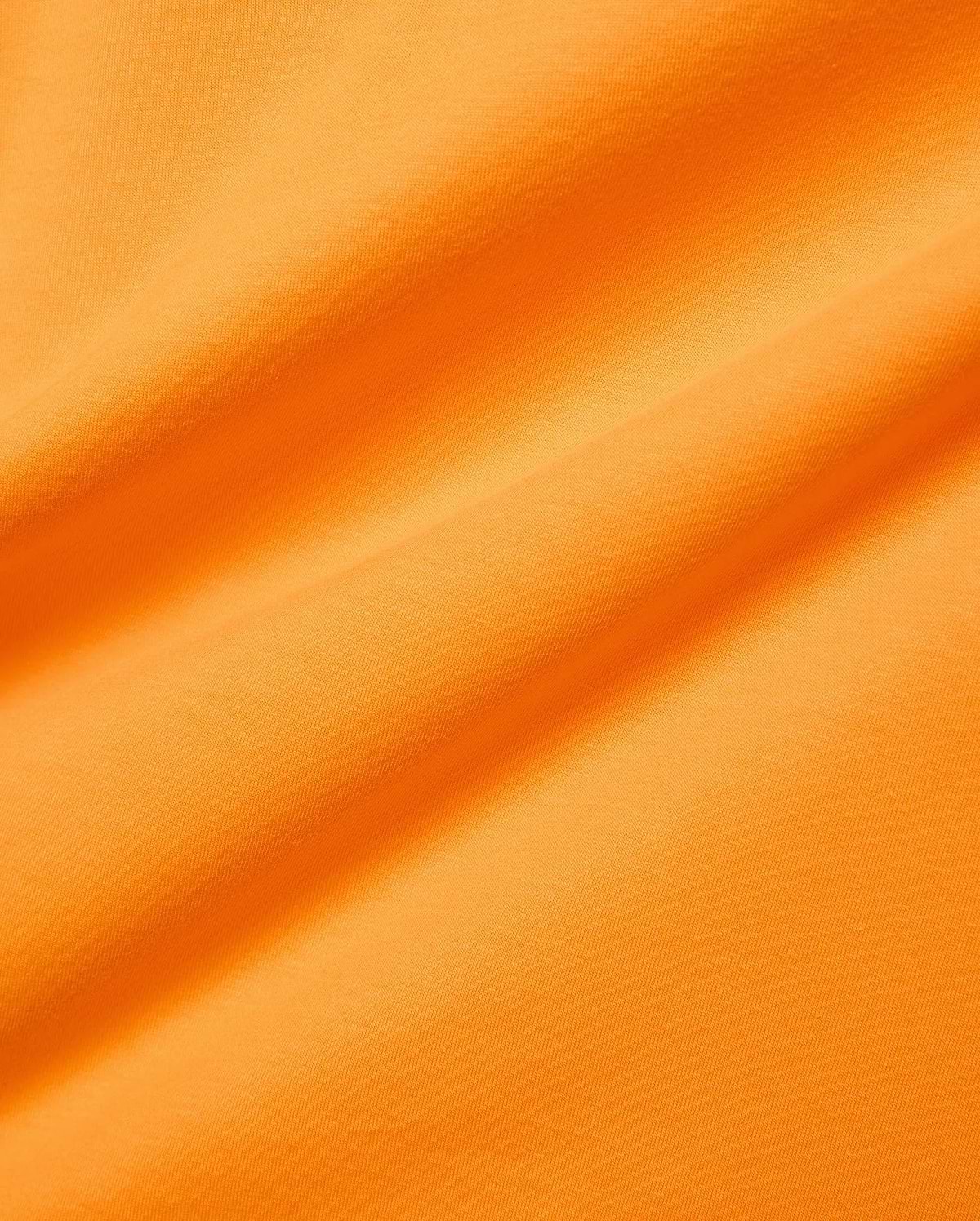 Mens Classic Crew Neck Tee in vibrant orange, crafted from soft jersey knit fabric with subtle folds, reflecting Psycho Bunny's bold, refined streetwear aesthetic. (6)