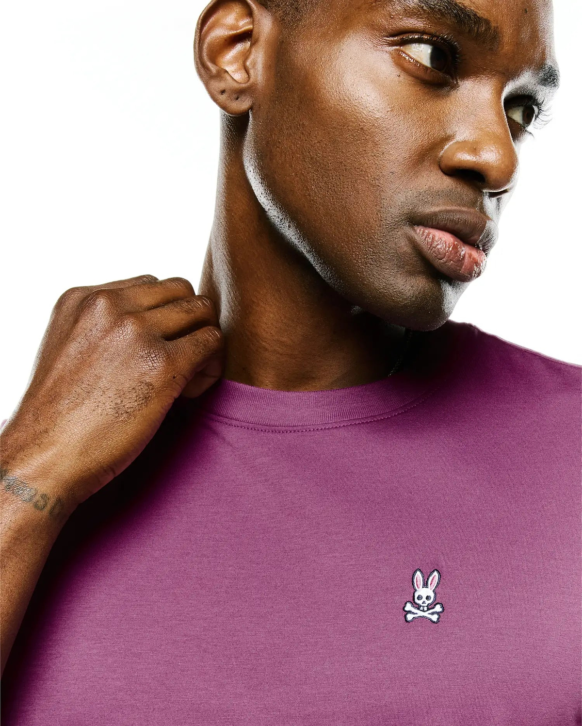 Mens Classic Crew Neck Tee in plum, featuring a smooth jersey knit and a small, embroidered white, black, and pink Psycho Bunny skull logo on the left chest.