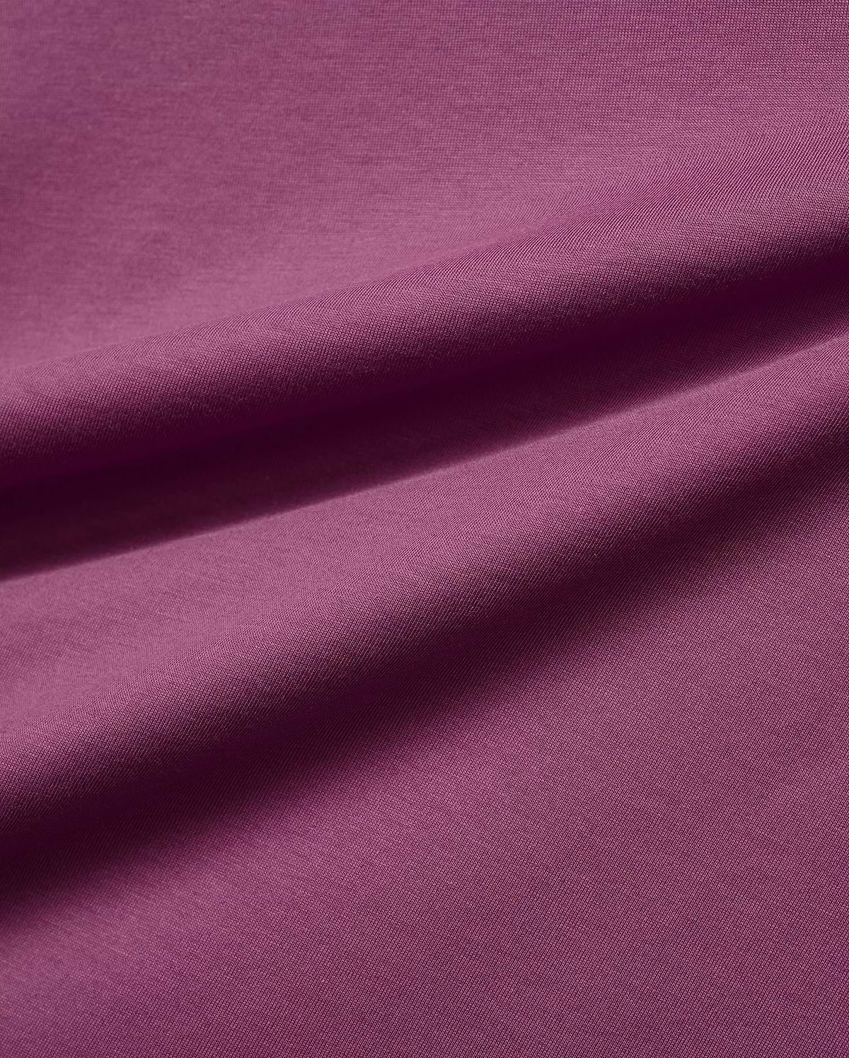 Mens Classic Crew Neck Tee in a luxurious, soft plum-colored jersey knit fabric, featuring subtle folds that highlight its smooth texture and rich, vibrant hue, embodying premium Psycho Bunny style.