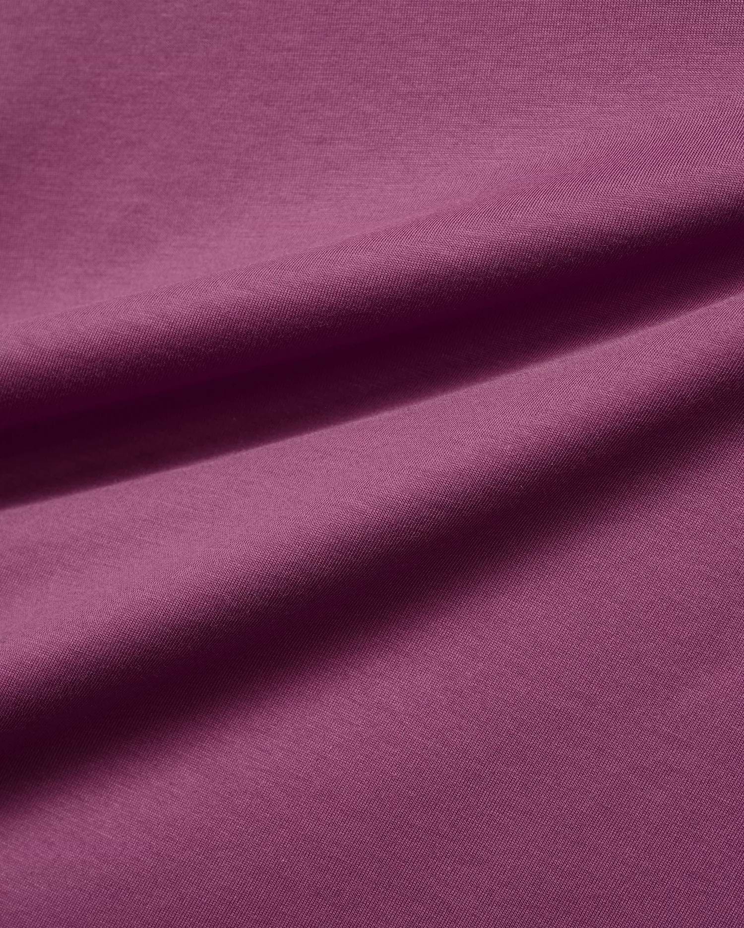 Mens Classic Crew Neck Tee in a luxurious, soft plum-colored jersey knit fabric, featuring subtle folds that highlight its smooth texture and rich, vibrant hue, embodying premium Psycho Bunny style.
