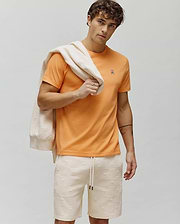 Vibrant Orange Mens Classic Crew Neck Tee, classic fit, soft jersey, featuring a small, embroidered Psycho Bunny skull logo with white, pink, and black details on the left chest. (4)