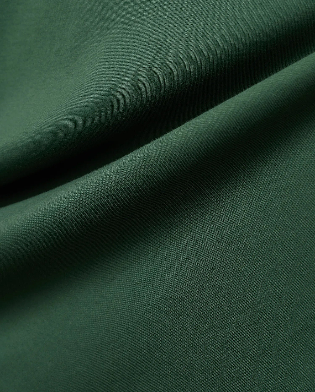 Mens Classic Crew Neck Tee in rich, deep forest green, crafted from premium, soft-touch jersey fabric, showcasing a refined, subtle knit texture and elegant, flowing drapes.