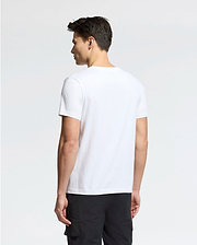 Person facing away, dressed in a Psycho Bunny MENS CLASSIC V NECK TEE - B6U100ARPC crafted from 100% Pima cotton and black pants, stands against a simple white background.