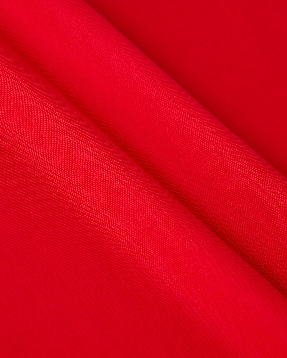 Close-up of vibrant red Pima cotton fabric draped in soft folds, showcasing the smooth texture and rich color reminiscent of the MENS CLASSIC V NECK TEE - B6U100CRPC by Psycho Bunny, adorned with the subtle elegance of its logo.