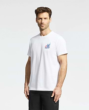 A man with short brown hair and a beard is wearing a Psycho Bunny MENS TORONTO TEE - B6U383F200, featuring a small colorful graphic on the left chest, along with black shorts, standing against a plain light background. (2)