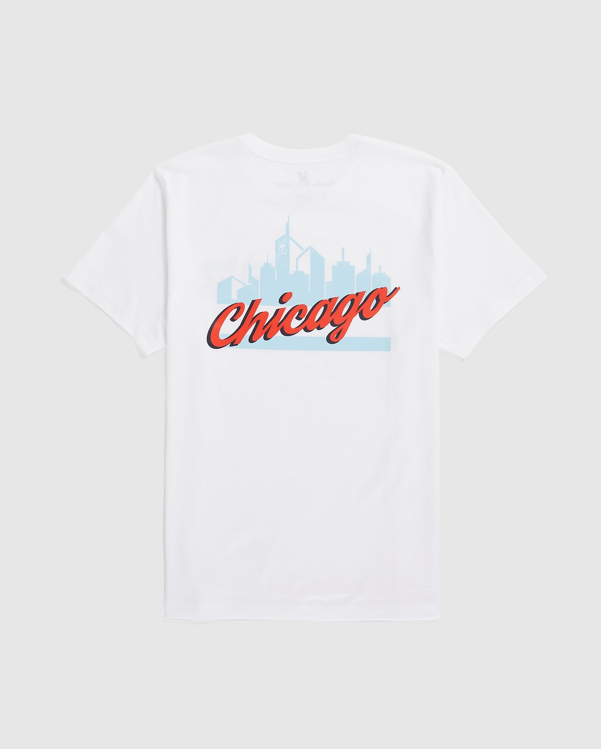 Psycho Bunny's MENS CHICAGO CITY TEE (B6U551W1PC) is a white Pima cotton shirt showcasing a light blue Chicago skyline with "Chicago" in bold, red cursive.