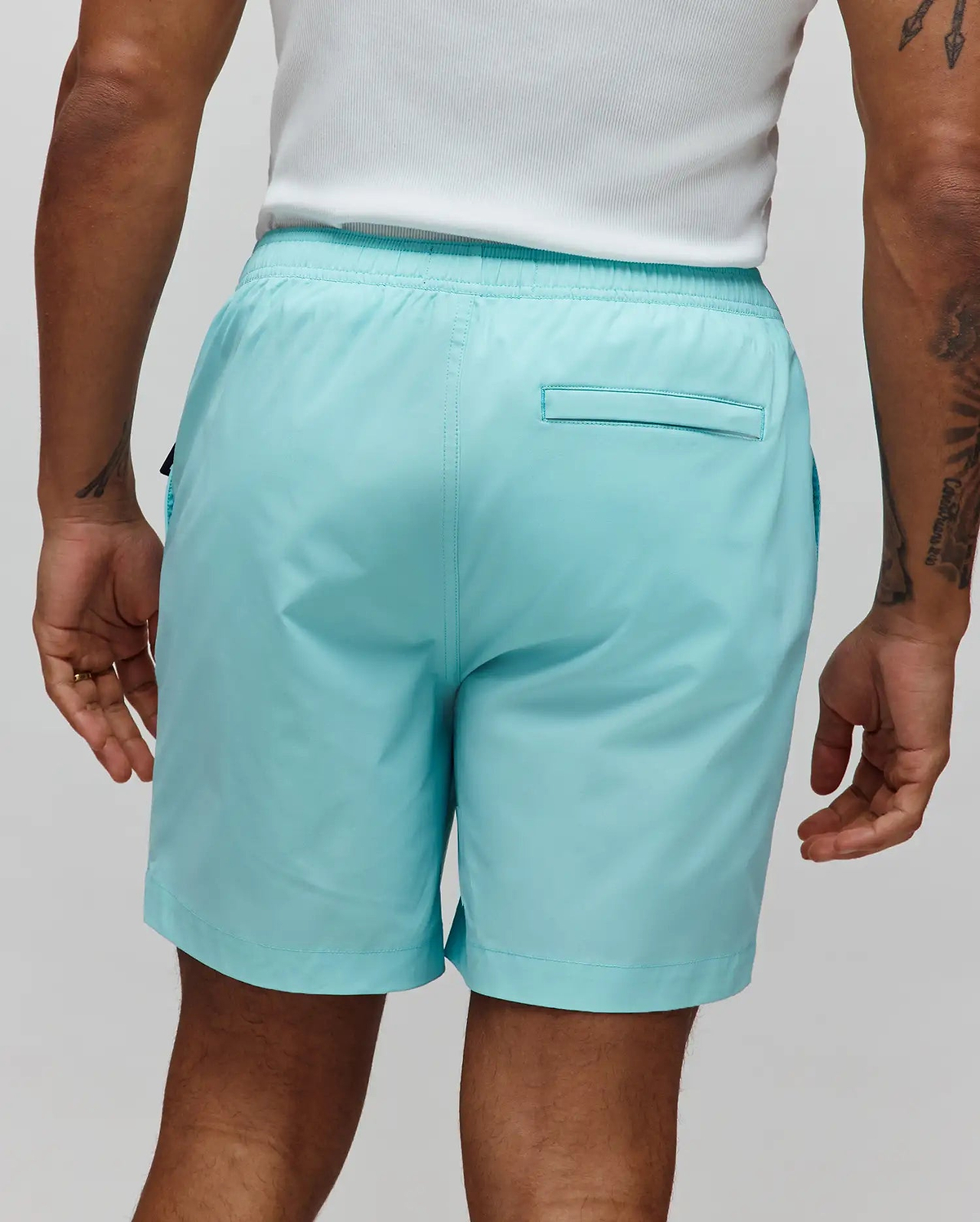 Mens Samos Hydrochromic Printed Swim Trunk in aqua, featuring a relaxed fit, smooth quick-dry fabric, elastic waistband, and a back welt pocket, with a hidden hydrochromic print that appears when wet.