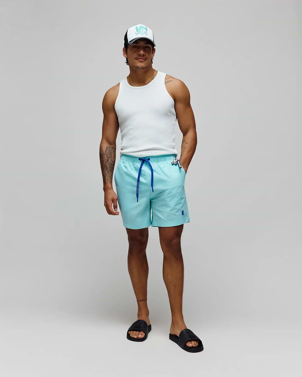 Mens Samos Hydrochromic Printed Swim Trunk, aqua, relaxed fit, smooth fabric, royal blue drawstring with branded Psycho Bunny toggle, small embroidered royal blue bunny skull logo left leg.
