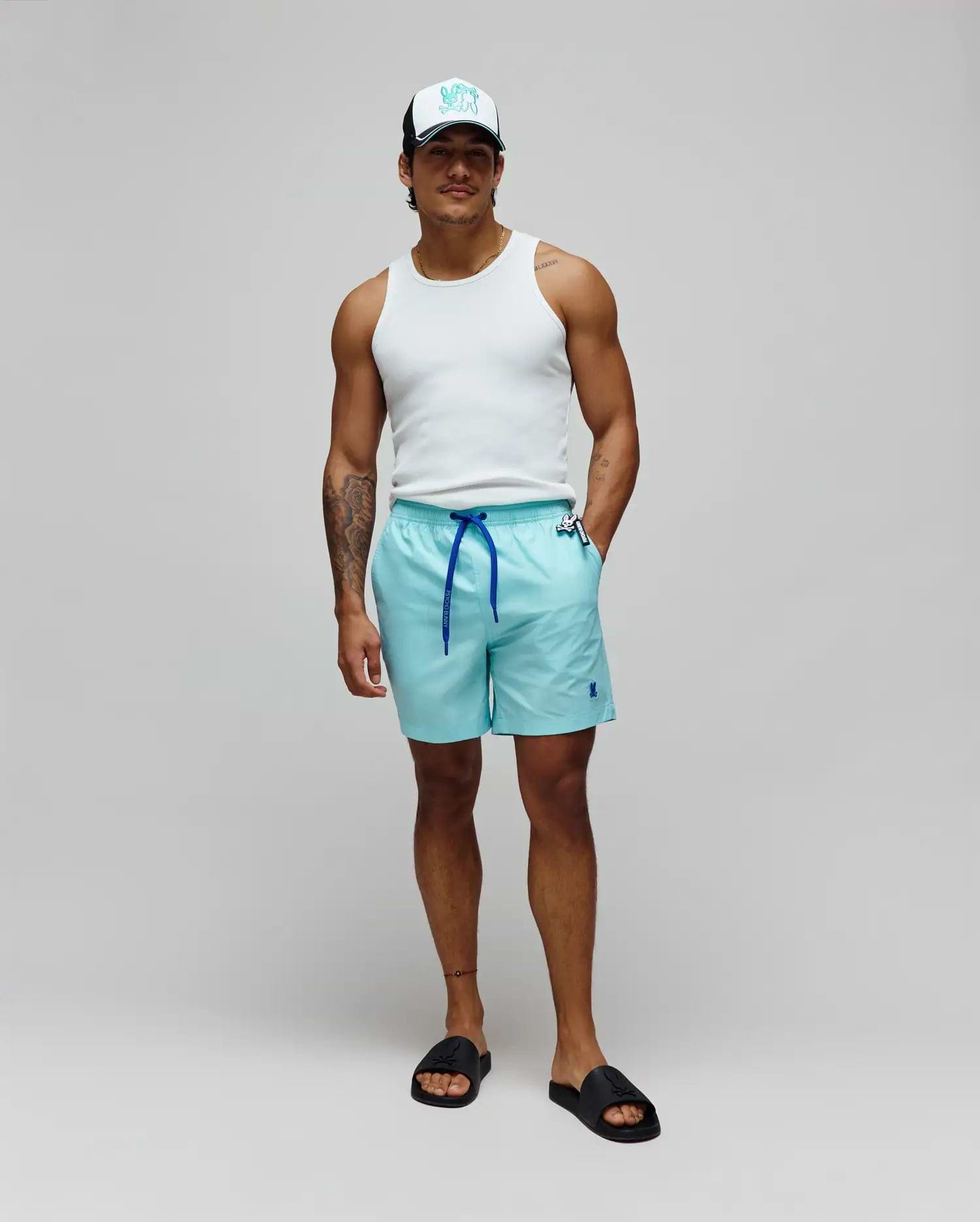 Mens Samos Hydrochromic Printed Swim Trunk, aqua, relaxed fit, smooth fabric, royal blue drawstring with branded Psycho Bunny toggle, small embroidered royal blue bunny skull logo left leg.