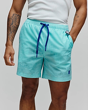 Mens Samos Hydrochromic Printed Swim Trunk in aqua, with a subtle all-over bunny skull pattern, royal blue drawstring featuring Psycho Bunny text, and an embroidered bunny skull logo on the left leg.