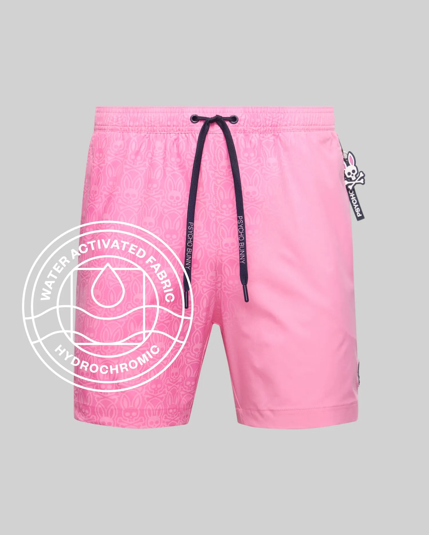 Mens Samos Hydrochromic Printed Swim Trunk in vibrant pink, featuring a subtle water-activated bunny skull pattern, navy drawstring with Psycho Bunny text, and a small logo tag.